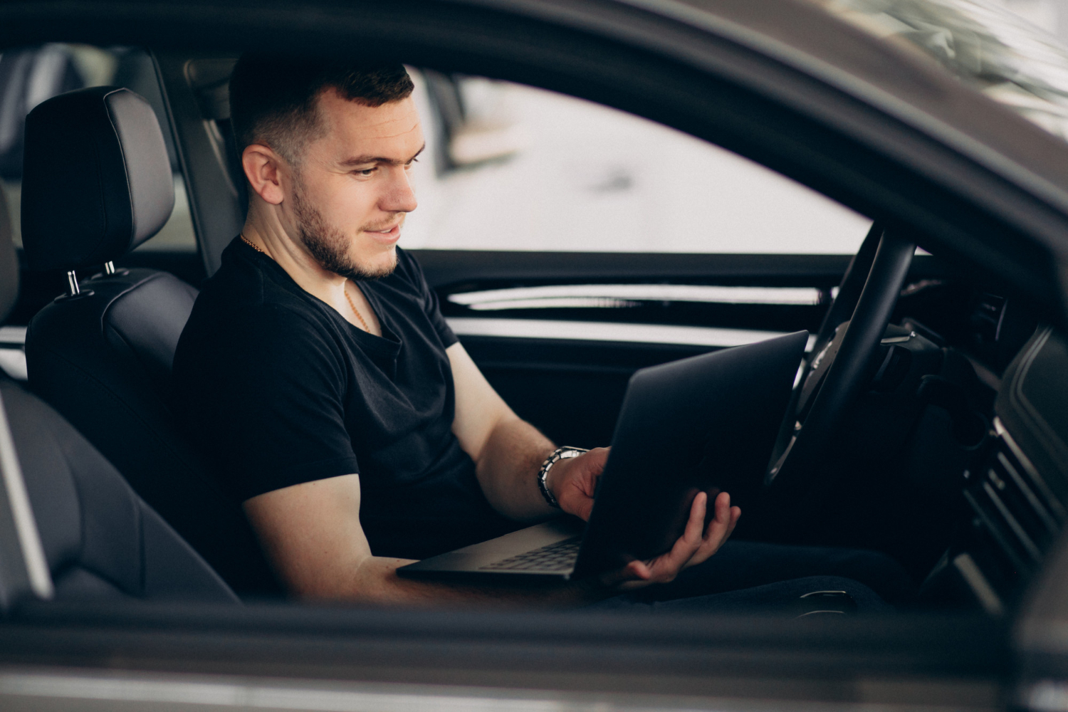 handsome man sitting car testing it